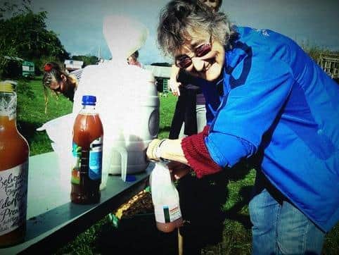 A visitor enjoys fresh apple juice at a Canalside Community Food open day in 2016.