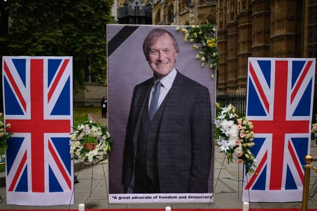 LONDON, ENGLAND - OCTOBER 18: A large photograph of murdered MP David Amess is seen outside the Houses of Parliament on October 18, 2021 in London, England. Sir David Amess, MP for Southend West, was stabbed to death while meeting with constituents in Leigh-on-Sea on Friday. A 25-year-old man, Ali Harbi Ali, was arrested at the scene and the attack is being treated by police as a terrorist incident. (Photo by Leon Neal/Getty Images)