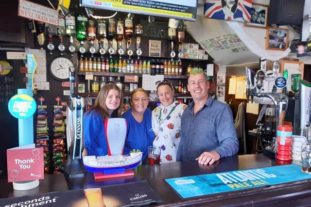 Kevin Murphy is pictured behind the bar at Murphy's with (l-r) assistant manageress Shannon Byrne who has worked at the bar for ten years, chief bar maid Jenny Daley who has worked there for 15 years, and regular customer Marie Heise.