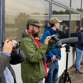 Birdwatchers lining up with their cameras to get a shot of the hoopoe. Photo by Rick Thompson