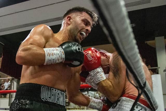 Danny Quartermaine has Dean Evans on the ropes in his third pro victory