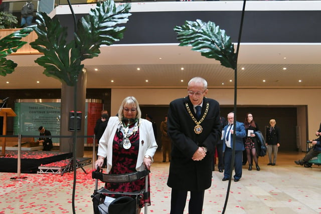 The Poppy Appeal 100th Anniversary launch by The Royal British Legion Peterborough Branch with a march from the war memorial to Queensgate . Mayor of Peterborough Steve Lane and Mayoress Margaret Lane place a poppy on the new sculpture EMN-211029-133108009