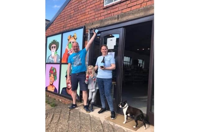 Jolyon and Charlotte outside taproom with their daughter and dog. Photo supplied