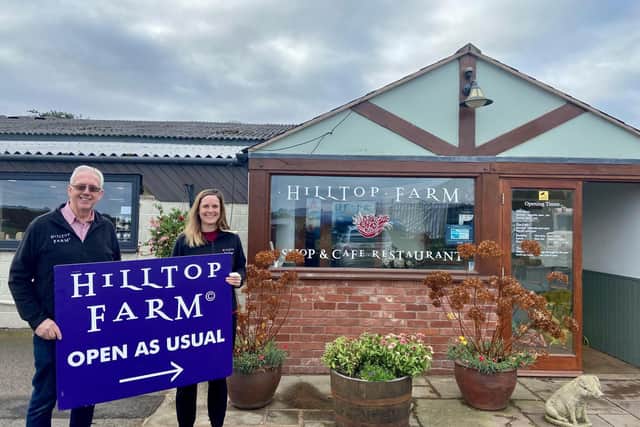 John Ellis (Owner) and Lotte Ellis (Farm Shop Manager) at Hilltop Farm with the sign they will be putting out in the road while the HS2 works take place.
