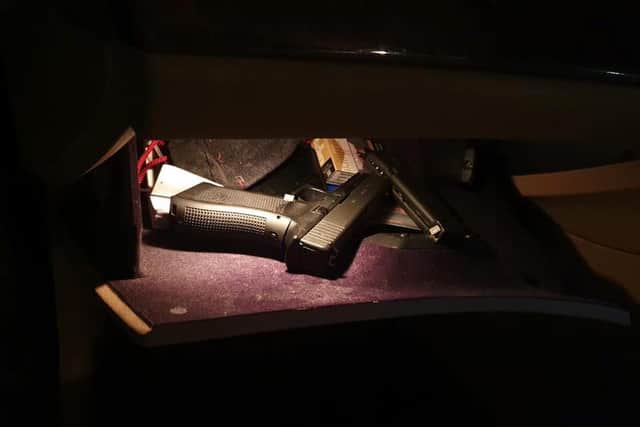 A black firearm was found inside the glove box.
