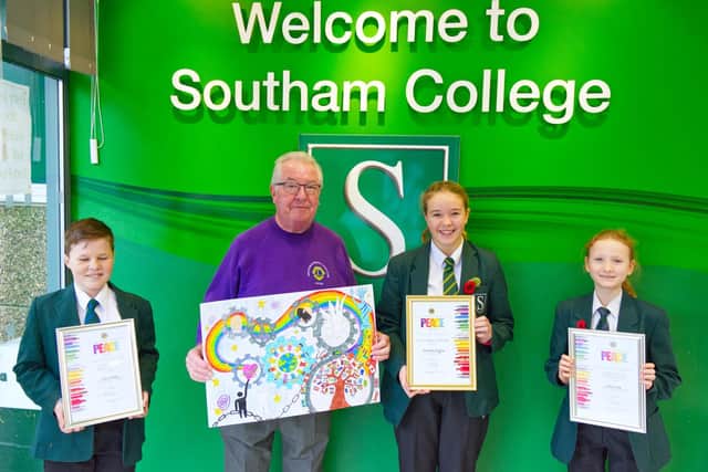 Peter Guy from the Southam and District Lions with the poster winner Matilda Hughes (on his left) and runners-up Eliana Cook and Toby Clarke