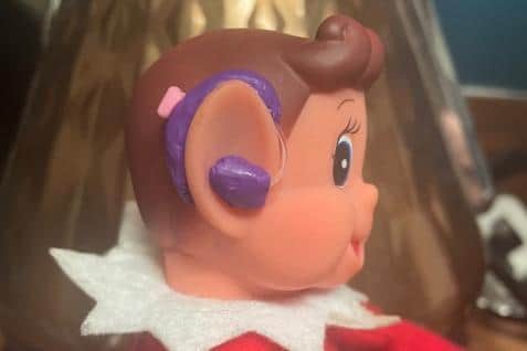 An Elf on the Shelf with a hearing aid as sold by Me & You.