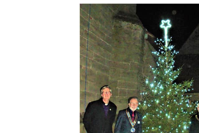 The Reverend Richard Suffern of St Margaret's church with Royal Leamington Spa Rotary Club president  Barry Andrews  and Whitnash mayor Cllr Adrian Barton at the switch on for the Tree of Light.