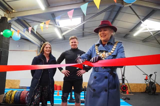 Olivia Kreigenfeld and Martin Browne, of Physical Formula, watch on as Leamington Mayor Cllr Susan Rasmussen officially opens their new gym.