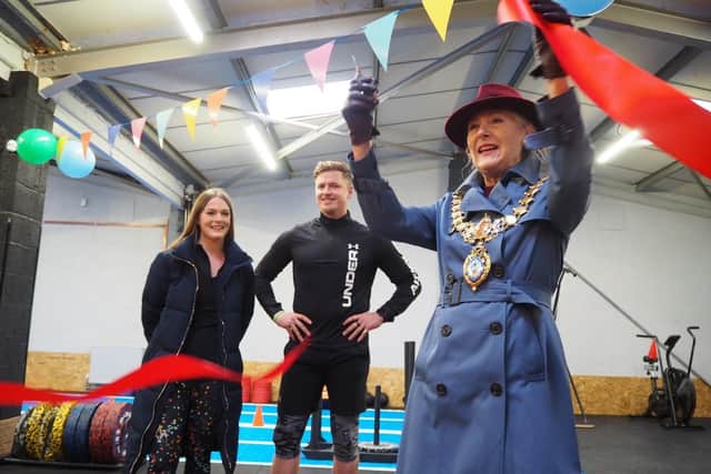 Olivia Kreigenfeld and Martin Browne, of Physical Formula, watch on as Leamington Mayor Cllr Susan Rasmussen officially opens their new gym.