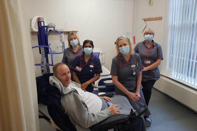 Nigel Fenwick with staff at the Warwick Myton Hospice.