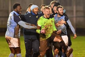 Rugby Town players celebrate with penalty shoot-out hero goalkeeper Ash Bodycote  PICTURE BY MARTIN PULLEY