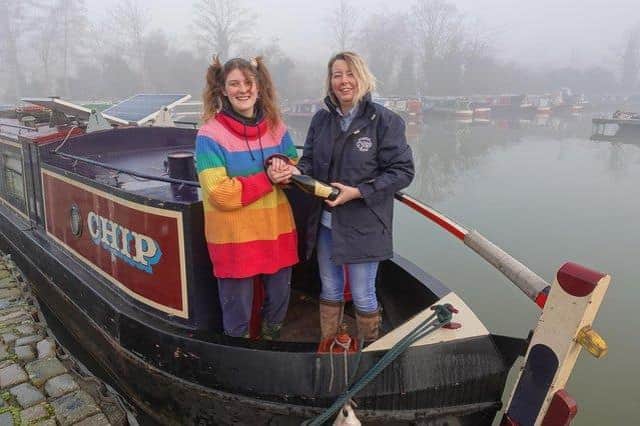 Braunston Marina Narrowboat Sales Manager Victoria Garfield presents circus performer Finley Guy with a bottle of Prosecco following her purchase of narrowboat CHIP – the marina’s first completed sale of 2022.