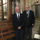 The chairman of Thomas Oken Charity, Clive Mason (left), with fellow trustee Terry Brown and the Rev Vaughan Roberts beside the Thomas Oken memorial plaque at St Mary's Church in Warwick. Photo supplied