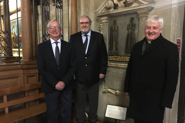 The chairman of Thomas Oken Charity, Clive Mason (left), with fellow trustee Terry Brown and the Rev Vaughan Roberts beside the Thomas Oken memorial plaque at St Mary's Church in Warwick. Photo supplied