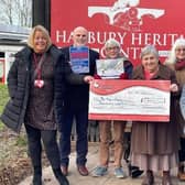 The cheque being presented to Myton’s community fundraising officer Louise Careless (left), with members of the Heritage committee and some of the artists. Photo supplied