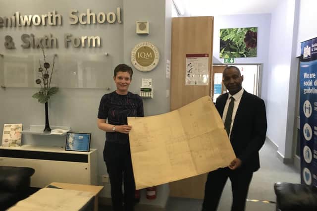 Alison Selwood, whose parents met while teaching at Kenilworth School in the 1960s, presents the original plans of the current school to executive head Hayden Abbott.
