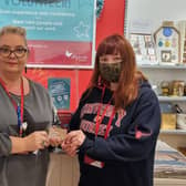 Kat and Lisa from The Myton Hospices retail team holding one of the gift cards. Photo supplied