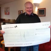 Nelson Social Club president Paul Stefani holding the cheque.  Photo supplied