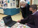 Computer café volunteers Jean and John Morgan offer computer advice at The Gap community centre on Monday mornings. Photo supplied