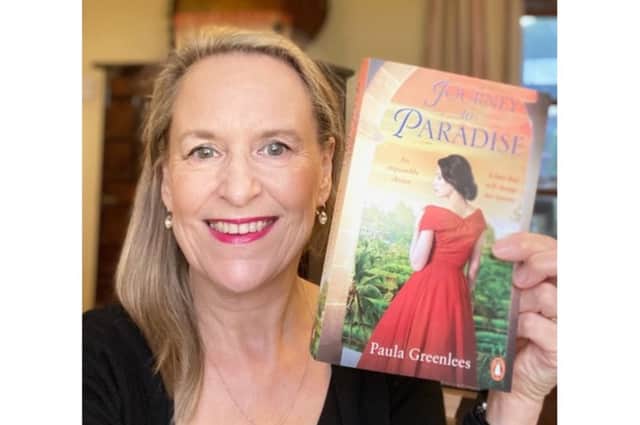 Paula Greenlees holding her book Journey to Paradise, which was published in December 2021. Photo supplied