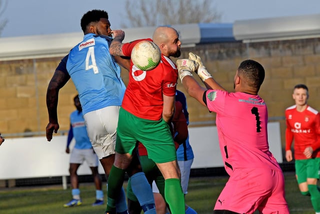 Jamal Clarke's header is punched clear