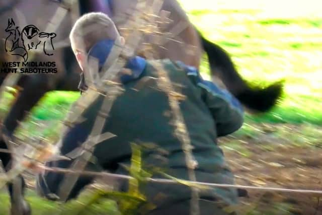 A Warwickshire Hunt member runs away with the dead fox.