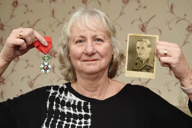 Gill Baxter holds a photo of her father Albert Tregoning pictured in Germany aged 21 in 1945 and his French order, Chevalier de la Legion D'honneur.
PICTURE: ANDREW CARPENTER