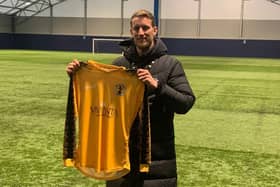 Carl Baker holds a Racing Club Warwick shirt,having been announced as their new Academy Football Manager