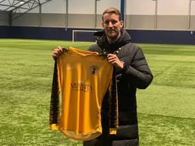 Carl Baker holds a Racing Club Warwick shirt,having been announced as their new Academy Football Manager