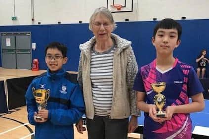 Under 13s boys Rex Wong (left) winner; and Ng Hong Wing Bertie (right) runner up; with trophies presented by Caroline Williams (General Secretary of the Warwickshire Table Tennis Association).