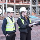 Students present some of the contents of the time capsule to Morgan Sindall Construction project director Richard Frape.
