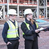 Students present some of the contents of the time capsule to Morgan Sindall Construction project director Richard Frape.
