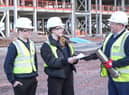 Students present some of the contents of the time capsule to Morgan Sindall Construction project director Richard Frape.