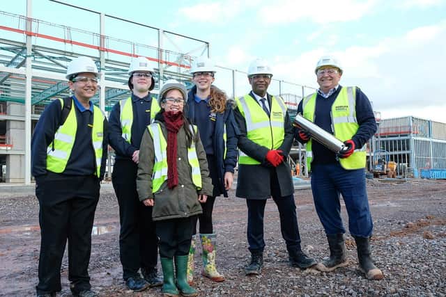 Students join Kenilworth School head Hayden Abbott at the new site to hand over the time capsule to Morgan Sindall Construction project director Richard Frape.