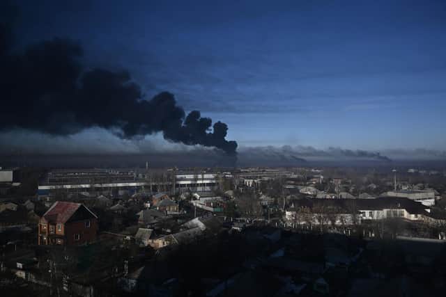 OPSHOT - Black smoke rises from a military airport in Chuguyev near Kharkiv on February 24, 2022. - Russian President Vladimir Putin announced a military operation in Ukraine today with explosions heard soon after across the country and its foreign minister warning a "full-scale invasion" was underway. (Photo by Aris Messinis / AFP) (Photo by ARIS MESSINIS/AFP via Getty Images)