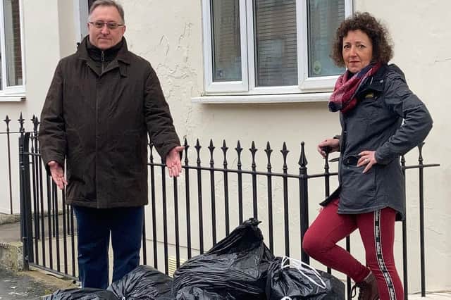 Colin Pigg and Carrie Terry point out a pile of rubbish bags outside a property in the Clarendon ward, Leamington.