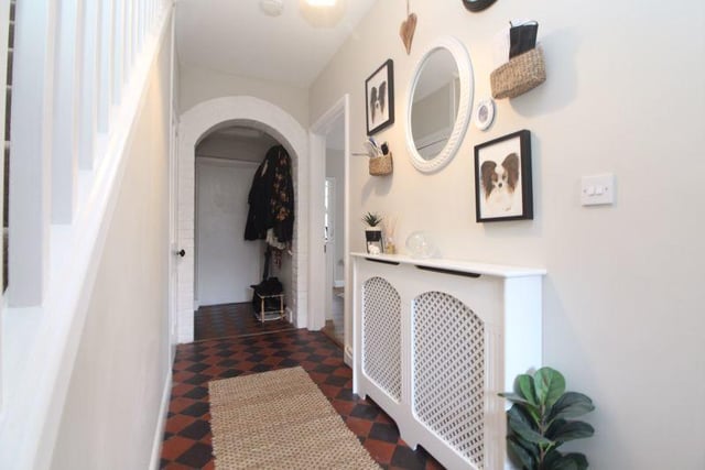 The character-tiled entrance hall has doors leading to two spacious reception rooms