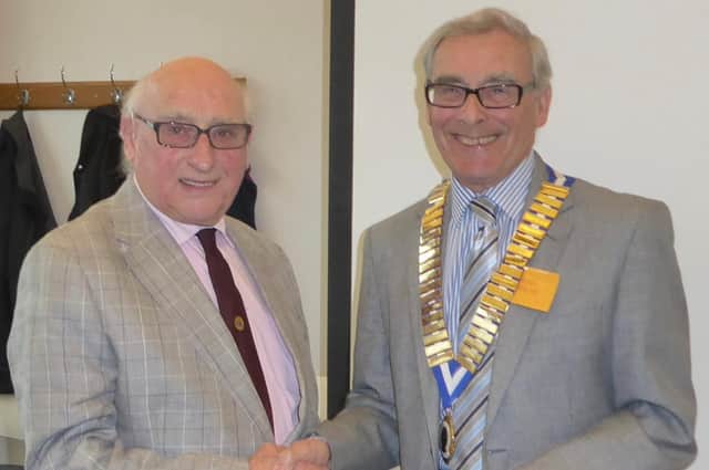 Outgoing Chairman Michael North (left) with incoming Chairman Brian Perkins receiving his chain of office. Photo supplied