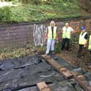 Volunteers laying a small section of railway track on the walk - a feature which serves to remind residents of the line's history.