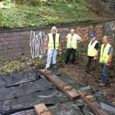 Volunteers laying a small section of railway track on the walk - a feature which serves to remind residents of the line's history.