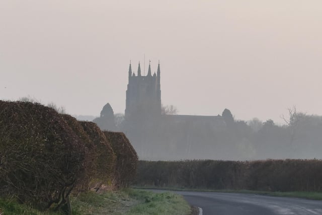 A view of Monks Kirby's St Edith's Church, looking ghostly in the morning mist.