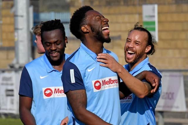 Justin Marsden (right) celebrates his double with Jamal Clarke (centre)