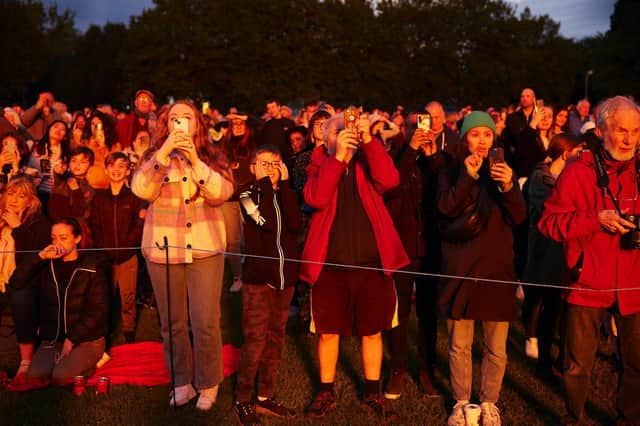 Onlookers watch the monument burn