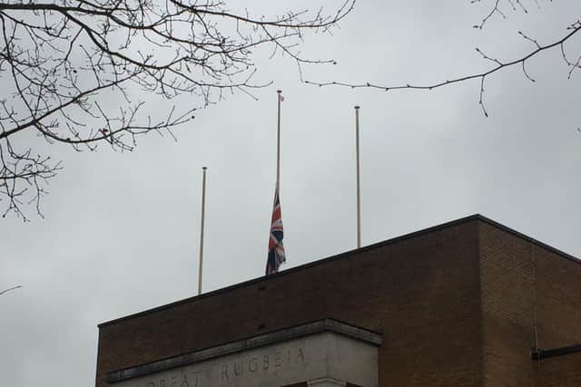 The flag flying at half mast at Rugby's town hall.