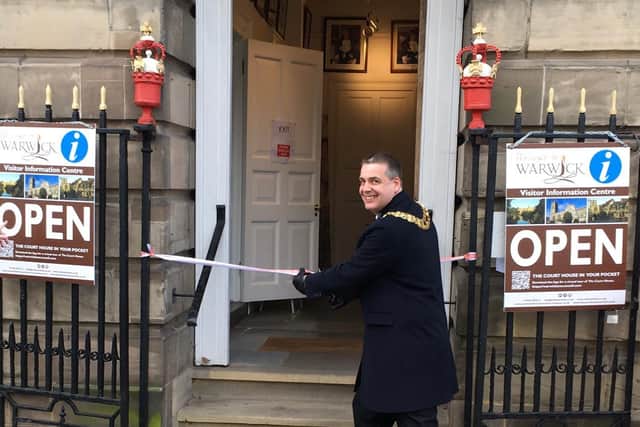 Cllr Terry Morris, Mayor of Warwick cutting the ribbon to reopen the visitor information centre which also marked the reopening of other businesses in the town. Photo by Rick Thompson