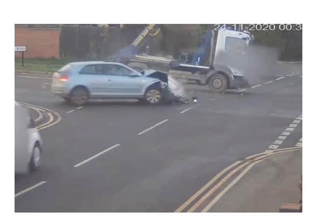 A still from the video which shows the shocking moment a reckless driver on the run from police smashes into skip lorry in Warwickshire - with a child in the car