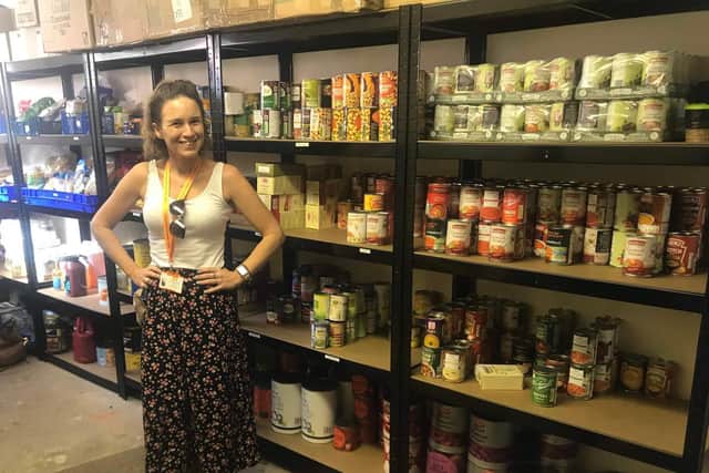 Carly Hadlum, operations support Worker at Helping Hands in the charity’s new-
look store room. Photo supplied