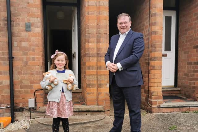 Lola receives her £175 donation from Wright Hassall’s Robert Lee. Photo supplied