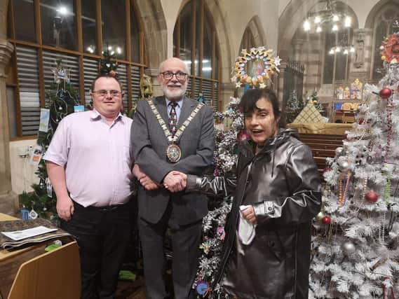 The mayor of Rugby, Cllr Bill Lewis, at the 2019 Festival of Christmas Trees with Bob and Susie from New Directions.